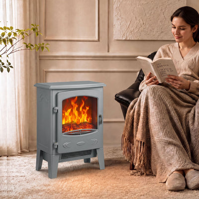 Grey electric fireplace heater beside an armchair in a cosy living room