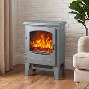 Grey electric fireplace heater with arched-window styling against a brick wall