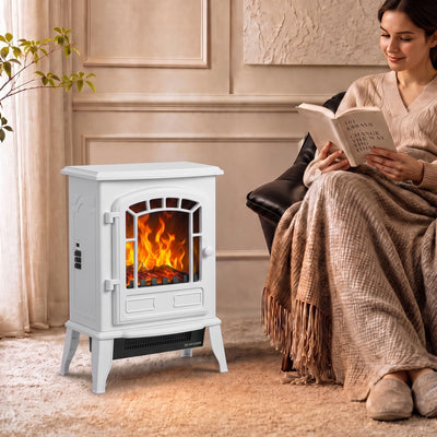 White electric fireplace stove glowing beside an armchair while a woman reads in a cosy living room
