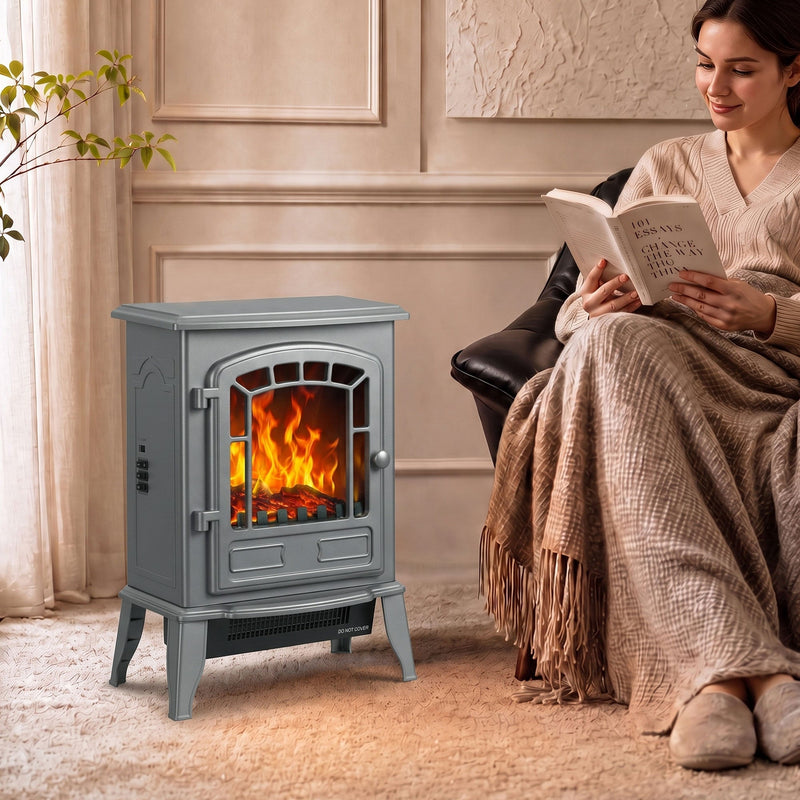 Grey electric fireplace stove beside a woman reading in an armchair