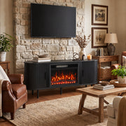 Black fireplace TV stand below a wall-mounted TV on a stone feature wall