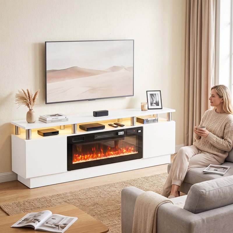 White fireplace TV stand with a woman relaxing on a sofa and a TV above
