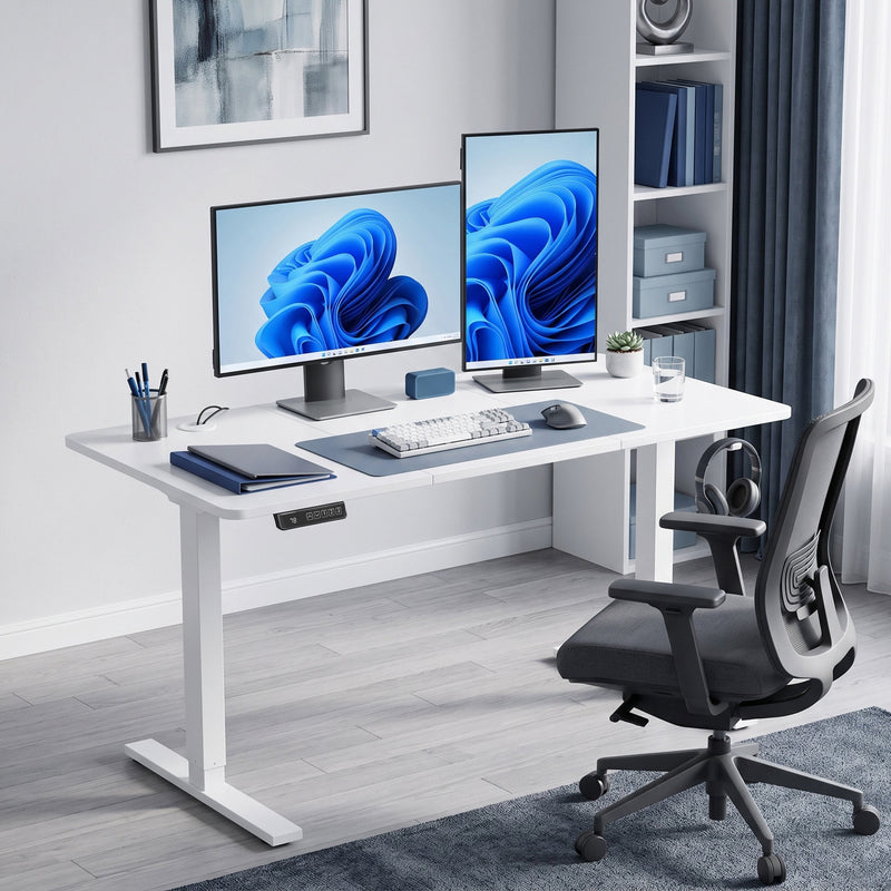 White standing desk set up as a home office with two monitors and a desk chair