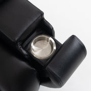 Close-up of the stainless steel cup holder inside the armrest