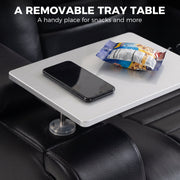 Removable tray table on the armrest holding a phone and snacks