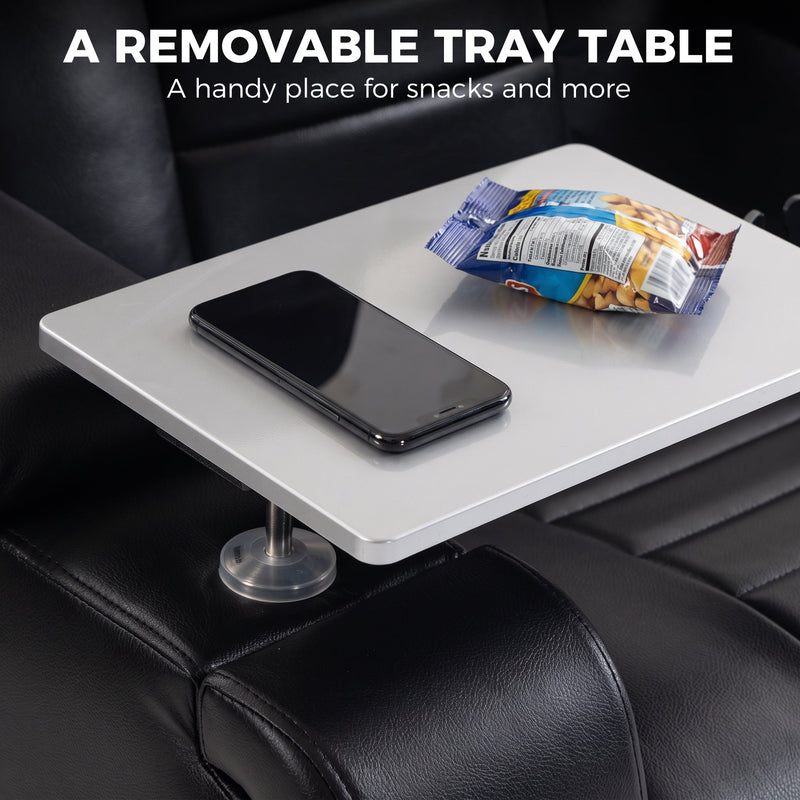Removable tray table on the armrest holding a phone and snacks