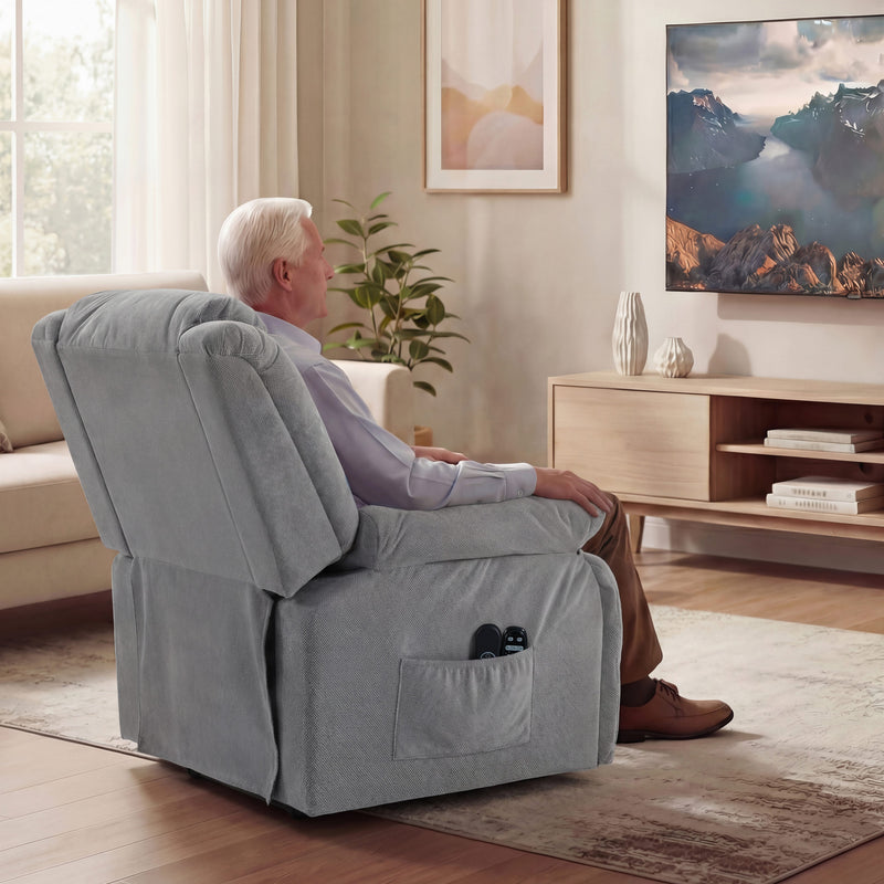Light grey recliner chair beside a television in a living room