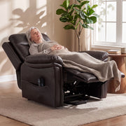 Woman resting under a blanket in the fully reclined riser recliner with the footrest raised
