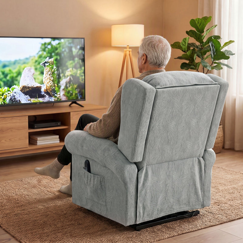 Rear view of an elderly man relaxing in the grey Homcom recliner chair watching television