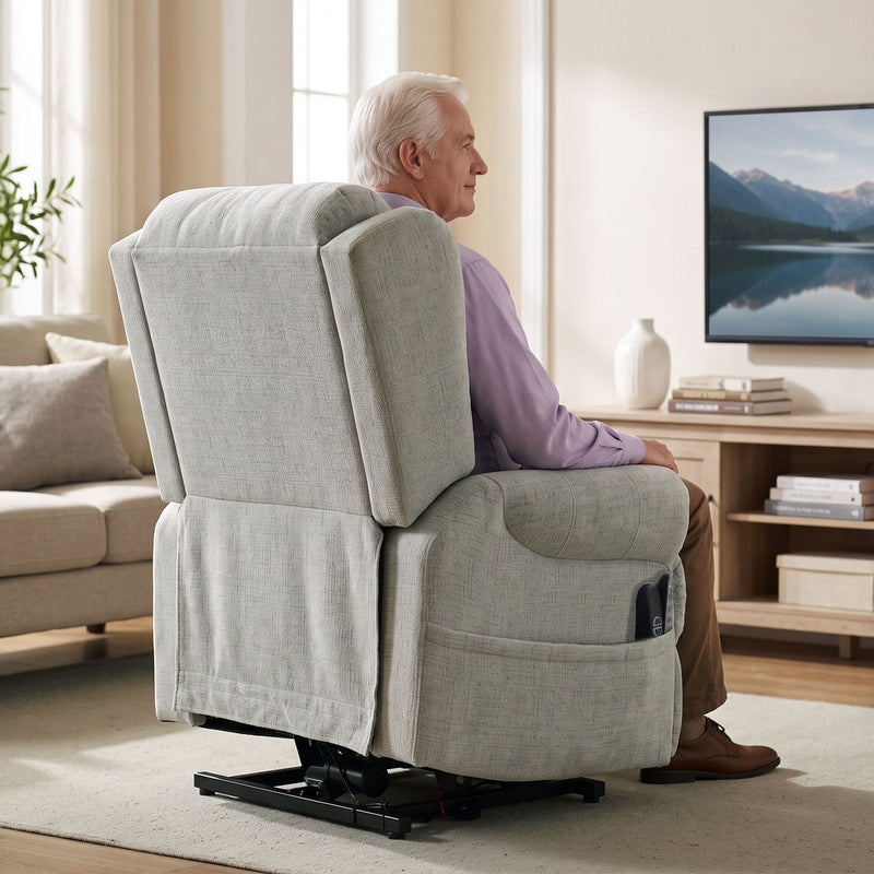 Rear view of a man sitting in the recliner chair watching TV in a living room