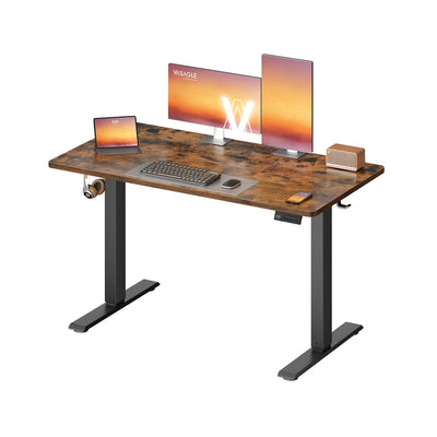Rustic brown electric standing desk with two monitors, a laptop and a speaker on the desktop
