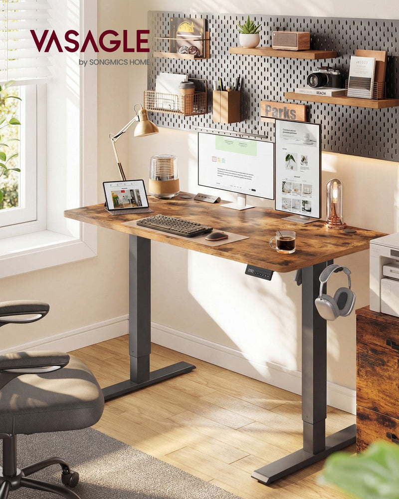 Rustic brown standing desk styled in a home office with a desk chair, shelving and plants