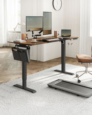 Electric standing desk in a home office lifestyle setting with a laptop, desk chair, and under-desk treadmill