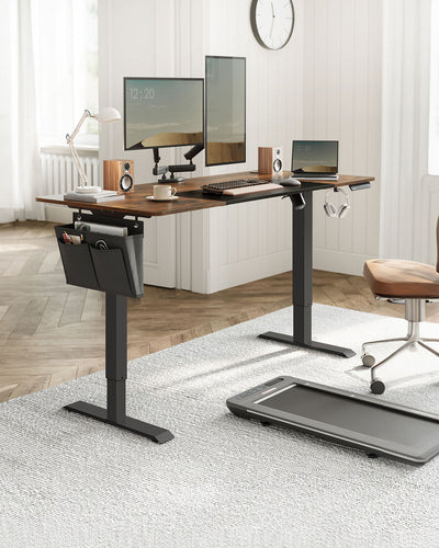 Electric standing desk in a home office lifestyle setting with a laptop, desk chair, and under-desk treadmill