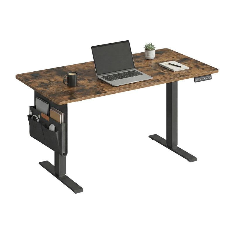 Standing desk set up with a laptop, coffee mug and notebook on the worktop