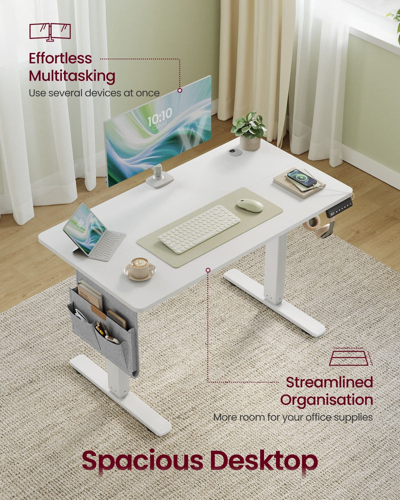 Angled view of the white 100 cm desktop holding a monitor, laptop, keyboard and mug