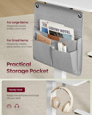 Close-up of the grey two-compartment side storage pocket and the under-desk hook holding headphones