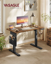 Rustic brown and ink black standing desk styled against a wall with a pegboard and plant