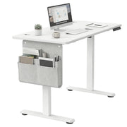Vasagle standing desk set up with monitor, keyboard and desk organiser, showing storage pocket