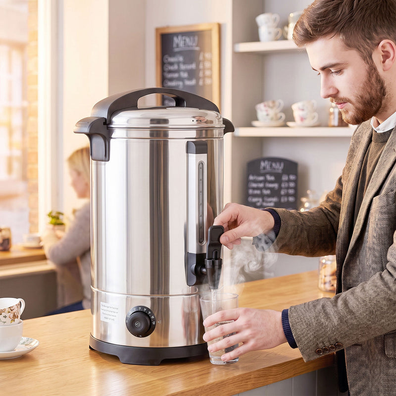 Man drawing hot water from the urn behind a cafe counter with a menu board behind