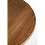 Close-up of curved metal footrest on bar stool