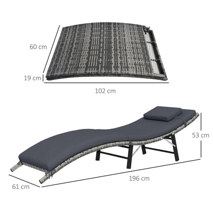 Image of an ergonomic curved rattan sun lounger with dark grey cushion