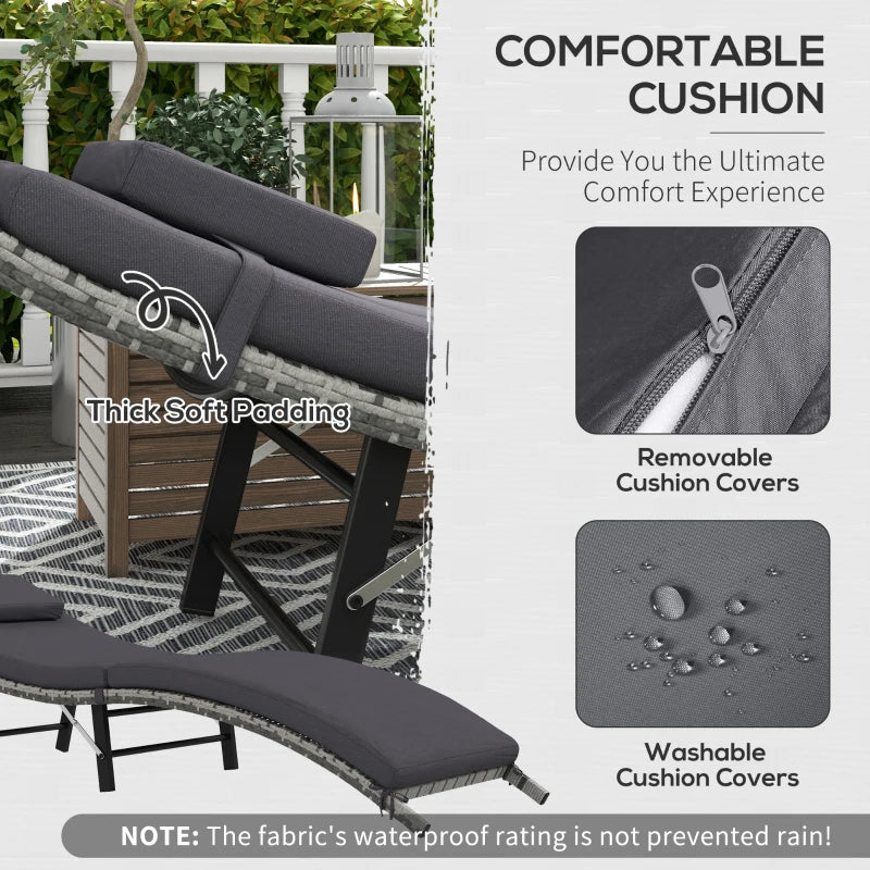 Image of an ergonomic curved rattan sun lounger with dark grey cushion