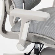 Close-up of a grey armrest and mesh seat on a white background