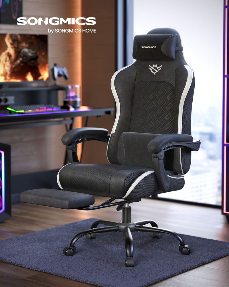 Reclining office chair beside a desk with a monitor, keyboard and neon lighting
