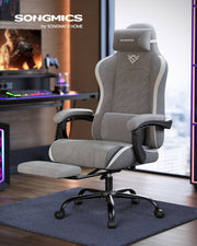 High-back desk chair in a home gaming room with the footrest pulled out
