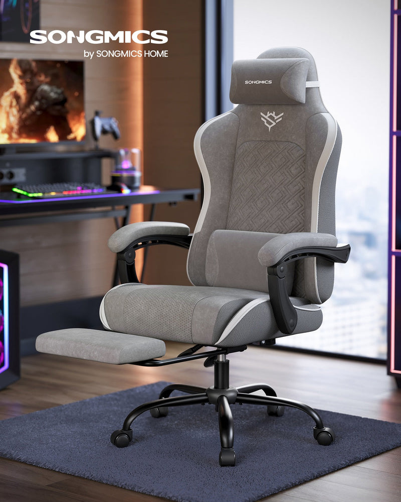 High-back desk chair in a home gaming room with the footrest pulled out