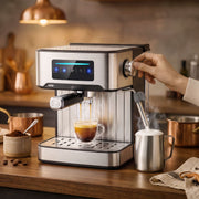 Espresso pouring into a glass cup with the steam wand frothing a jug of milk