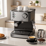 Espresso machine on a kitchen worktop with two cups warming on the top plate