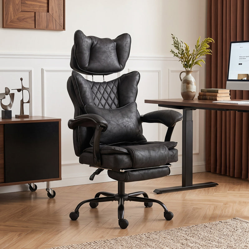 Black executive office chair styled in a modern home office with a standing desk