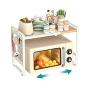 Cream white and light bamboo expandable microwave shelf standing over a microwave, loaded with plates, jars and a toaster