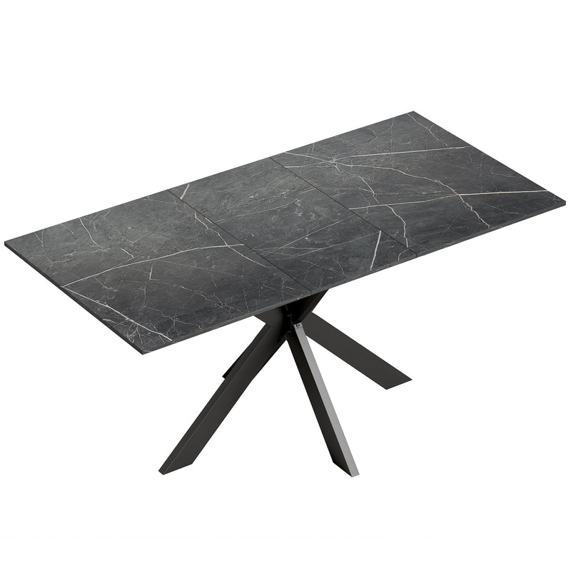 Black marble effect extendable dining table with black steel cross legs on a plain background
