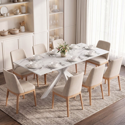 White marble effect extendable dining table laid for dinner with beige chairs