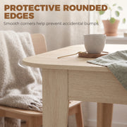 Rounded corner of the tabletop beside a chair with a blanket draped over it