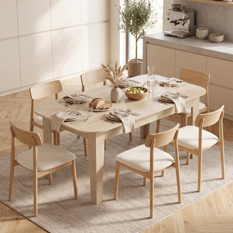 Table laid for a meal with bread and salad, upholstered chairs around it