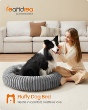 Lifestyle photo of a dog resting in the Feandrea dove grey pet bed beside its owner in a living room
