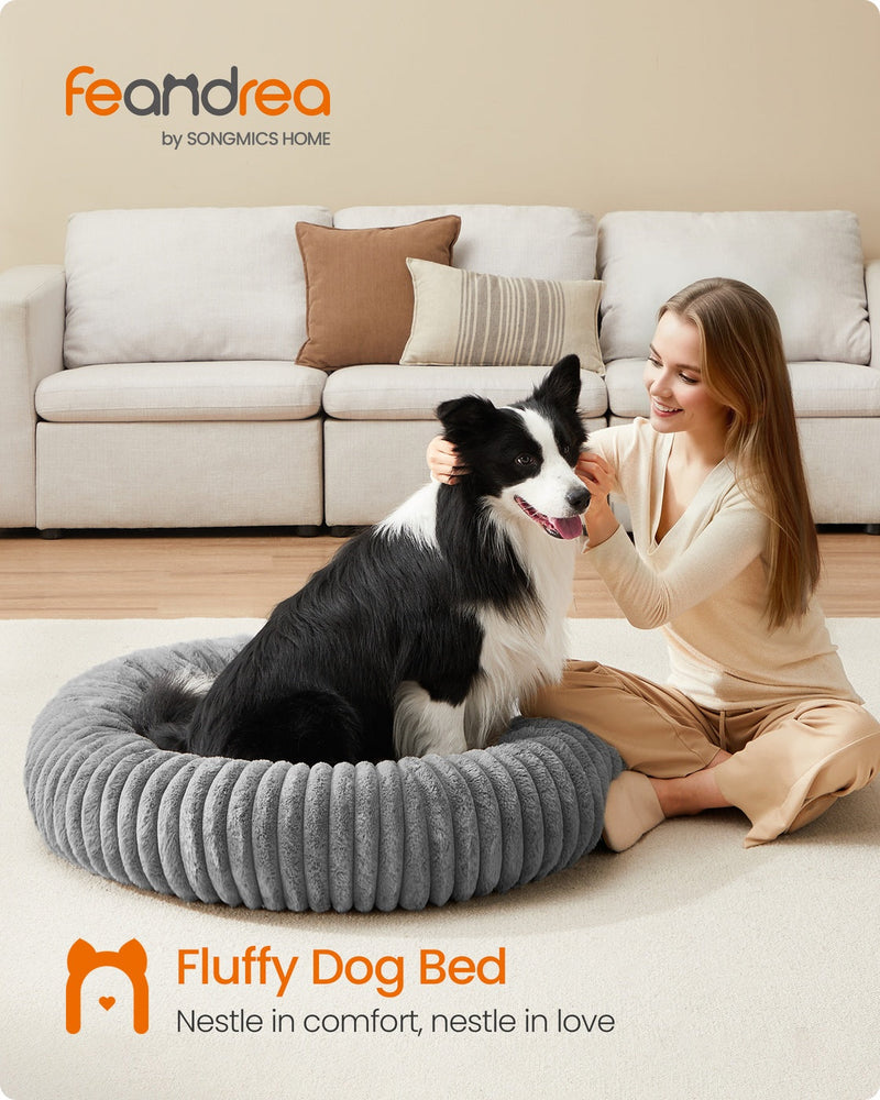 Lifestyle photo of a dog resting in the Feandrea dove grey pet bed beside its owner in a living room
