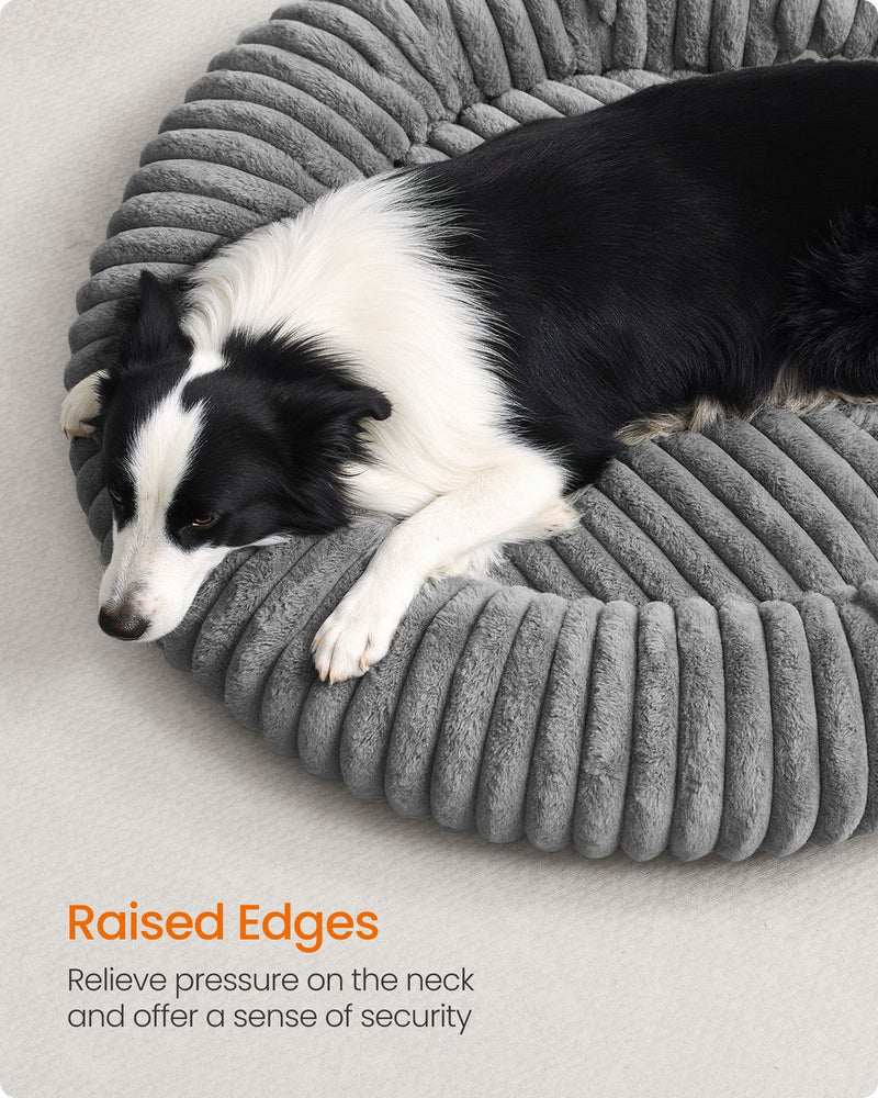 Close-up of a dog leaning against the raised rim edge of the Feandrea dove grey pet bed