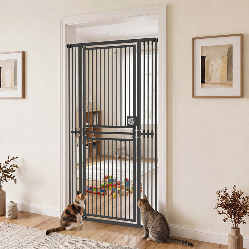 Black cat gate in a hallway doorway with two cats and a room of toys behind it