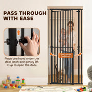 Hand lifting the door latch to open the gate with one hand while carrying a child
