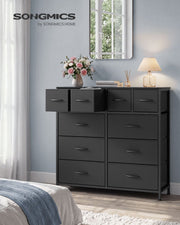 Ink black 10 drawer fabric chest in a bedroom with top drawers open beside a mirror and lamp