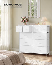 Cloud white 10 drawer fabric chest in a bedroom with top drawers open beside a mirror and lamp