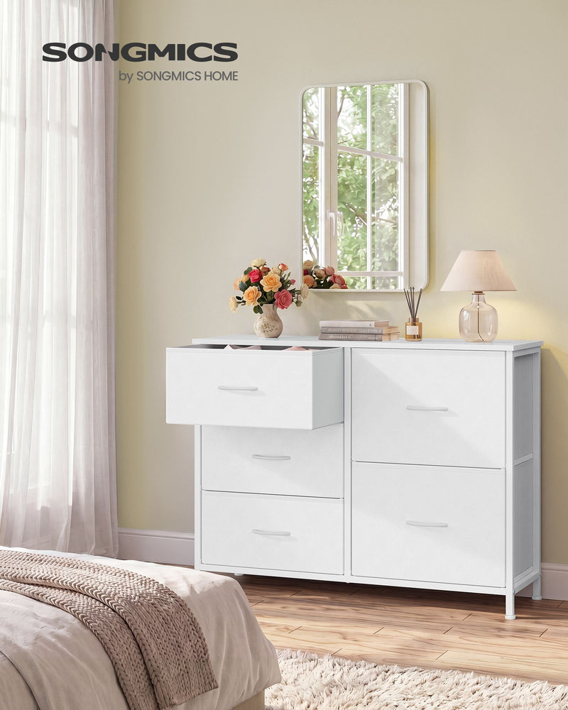Cloud white 5 drawer fabric chest in a bedroom with one drawer open beside a mirror and lamp
