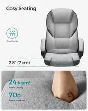 Hand pressing into the dove grey seat cushion, labelled 24 kg per cubic metre foam density and 70D hardness