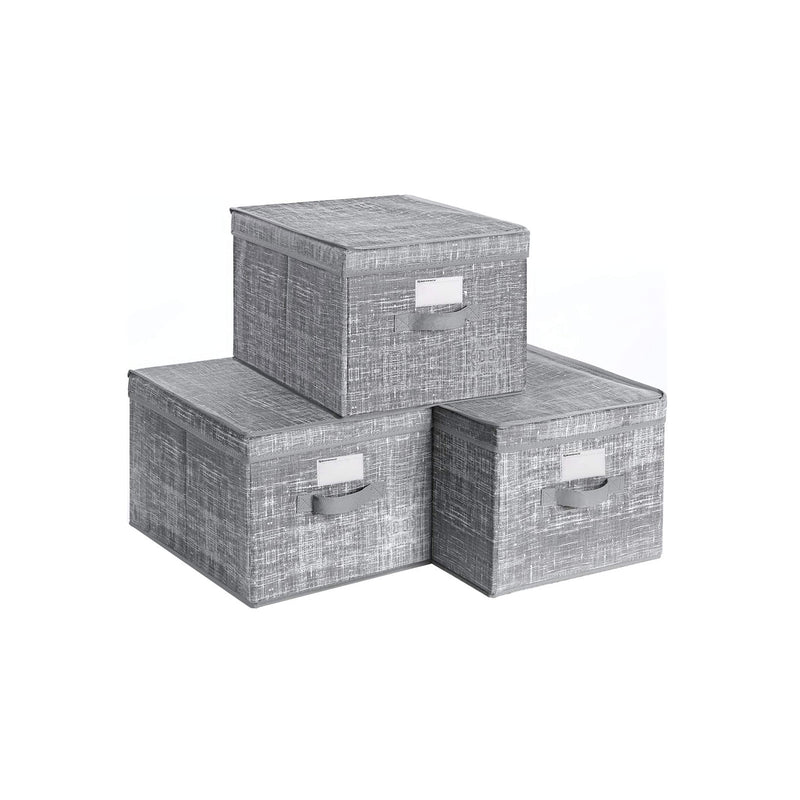 Studio shot of three grey fabric storage boxes with lids and label holders stacked together