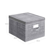 Storage boxes styled in a bedroom setting holding folded clothing